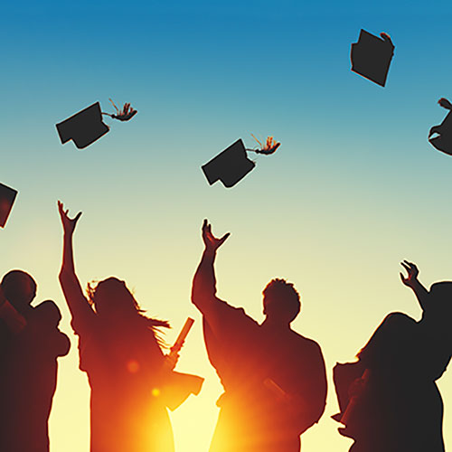Graduates throwing caps in the air