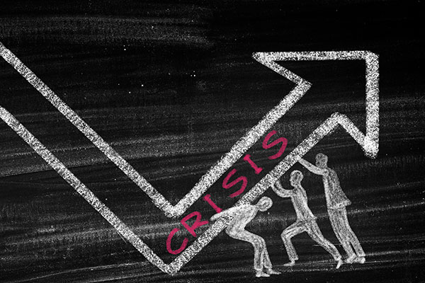 chalk drawing of three people lifting an arrow that says crisis