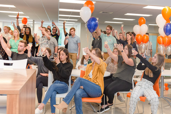 Reveneer employees celebrating at a company meeting