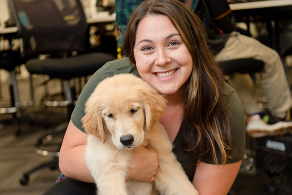 female employee holding one of the company dogs