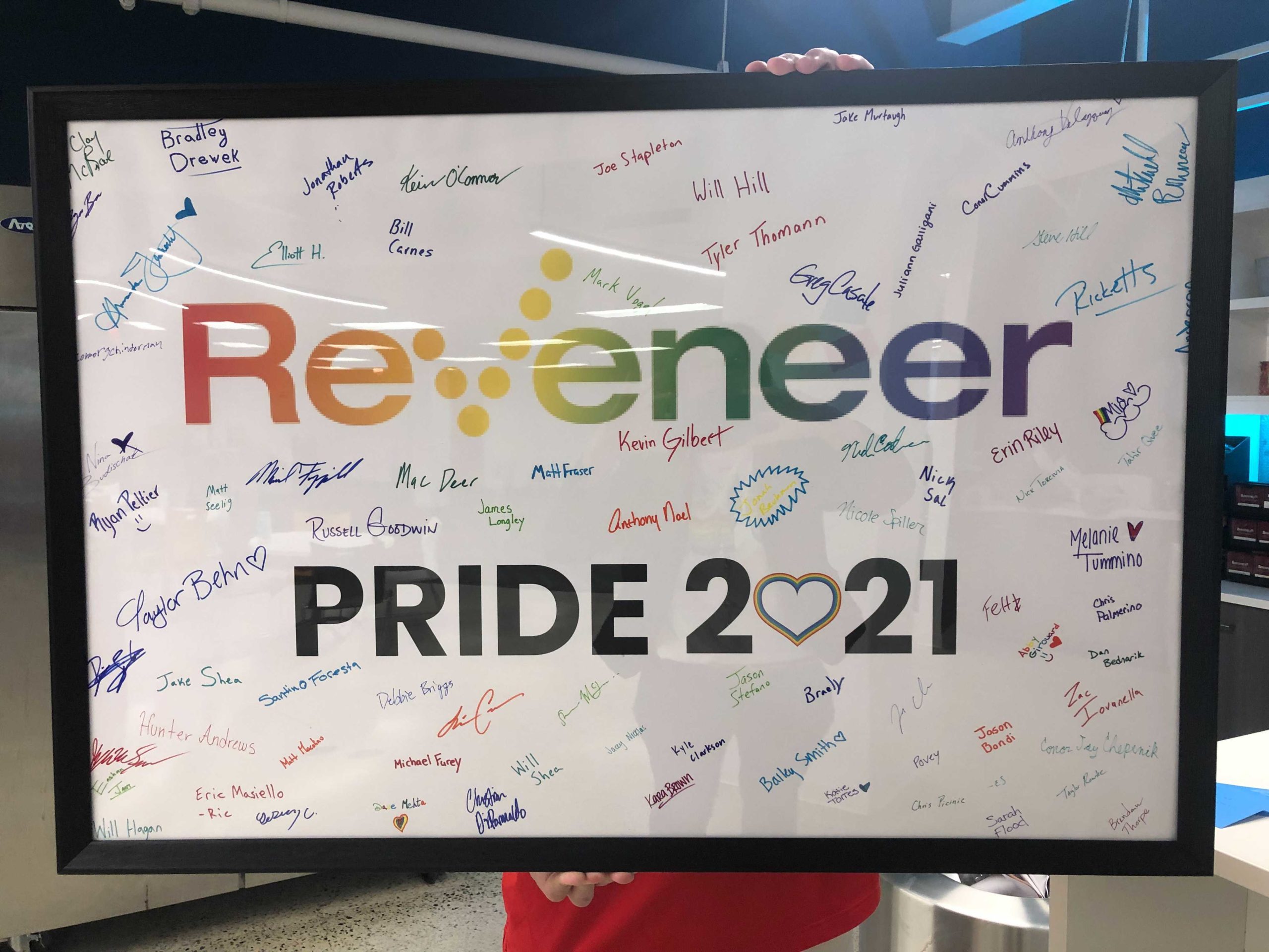 Reveneer Pride 2021 sign with employee signatures