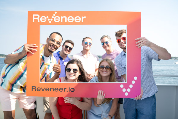 Reveneer employees on a boat standing inside a Reveneer frame